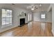 Bright and open living area with fireplace, large windows, and hardwood floors at 1284 Warsaw Rd, Roswell, GA 30076