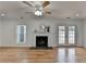 Bright living room with a fireplace, hardwood floors and a doorway to the backyard at 1284 Warsaw Rd, Roswell, GA 30076