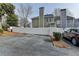 Parking area behind townhome with a white fence and trees at 1284 Warsaw Rd, Roswell, GA 30076