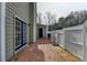 This back patio has brick pavers, a door to the house, and a fenced area at 1284 Warsaw Rd, Roswell, GA 30076