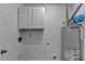 This utility area features white cabinets, a water heater, and mechanicals at 1284 Warsaw Rd, Roswell, GA 30076