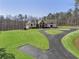 Aerial view of a home with a lush lawn, long driveway, and mature trees at 5222 N Helton Rd, Winston, GA 30187