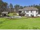 Expansive backyard with an in-ground pool, lush lawn, and a gazebo, perfect for outdoor enjoyment at 5222 N Helton Rd, Winston, GA 30187