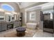 Luxurious primary bathroom featuring a freestanding tub, separate shower, and double vanities at 5222 N Helton Rd, Winston, GA 30187