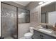 Modern bathroom features a sleek glass-enclosed shower with decorative tile accents, a granite vanity, and a toilet at 5222 N Helton Rd, Winston, GA 30187