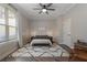 Serene bedroom with a ceiling fan, a window with blinds, and a bed with accent lighting and decor at 5222 N Helton Rd, Winston, GA 30187
