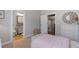 Cozy bedroom features a decorative mirror, pink bedding, and adjacent bathroom, creating a comfortable retreat at 5222 N Helton Rd, Winston, GA 30187