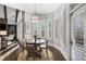 Sunny breakfast nook with bay windows, white shutters, and views of the natural surroundings at 5222 N Helton Rd, Winston, GA 30187