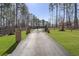 Long driveway through a stately entrance and professional landscaping at 5222 N Helton Rd, Winston, GA 30187