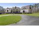 Stunning exterior of a grand home with lush lawn and a curved driveway at 5222 N Helton Rd, Winston, GA 30187