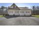 Four-car garage with white doors and stone accents, offering ample parking and storage space at 5222 N Helton Rd, Winston, GA 30187