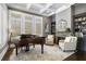Elegant living room with coffered ceiling, piano, fireplace, and built-in bookshelves at 5222 N Helton Rd, Winston, GA 30187