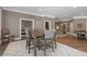 Spacious living area featuring a large wooden table with chairs, complemented by a stylish white patterned rug at 5222 N Helton Rd, Winston, GA 30187