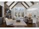 Bright living room with vaulted ceilings, stone fireplace, and wall of windows at 5222 N Helton Rd, Winston, GA 30187