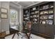Office with built-in shelving, large window, glass top desk, and rolling desk chair at 5222 N Helton Rd, Winston, GA 30187