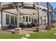 Spacious covered outdoor living area with hot tub, ceiling fans, and stone and wood beam details at 5222 N Helton Rd, Winston, GA 30187