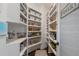 Walk-in pantry with ample shelving for food storage, organized with baskets and clear containers at 5222 N Helton Rd, Winston, GA 30187