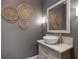 Stylish powder room boasts vessel sink, granite countertop, and decorative wall art at 5222 N Helton Rd, Winston, GA 30187