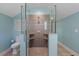 Modern shower with frameless glass, gray tile, and built-in shelves, creating a sleek and functional spa-like experience at 5222 N Helton Rd, Winston, GA 30187