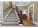 Welcoming staircase with carpeted steps and wood railing, leading to a laundry room and other areas of the home at 5222 N Helton Rd, Winston, GA 30187