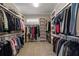 Large walk-in closet with custom shelving and ample storage space for clothes at 5222 N Helton Rd, Winston, GA 30187
