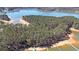An aerial view shows a secluded lakefront property with dock surrounded by lush trees and calm waters at 5400 Kings Camp Rd Se B-34, Acworth, GA 30102