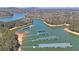 A stunning aerial view shows multiple boat docks on a serene lake surrounded by dense forests at 5400 Kings Camp Rd Se B-34, Acworth, GA 30102