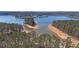 Scenic aerial view of Lake Lanier featuring sandy beaches, lush forests, and boat docks, showcasing lake living at 5400 Kings Camp Rd Se B-34, Acworth, GA 30102