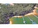 Aerial view showcasing a private dock with boat slip tucked away on a tree-lined cove and lake at 5400 Kings Camp Rd Se B-34, Acworth, GA 30102
