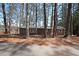 Charming lake house surrounded by tall trees, offering a peaceful, nature-filled retreat with a green roof at 5400 Kings Camp Rd Se B-34, Acworth, GA 30102