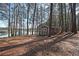 Lake house surrounded by trees leading to a serene lake view, perfect for a tranquil and nature-filled getaway at 5400 Kings Camp Rd Se B-34, Acworth, GA 30102