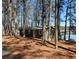 Cozy waterfront cabin nestled among trees with serene lake views and private dock access at 5400 Kings Camp Rd Se B-34, Acworth, GA 30102