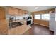Bright kitchen features stainless steel appliances, wood cabinets, and beautiful granite countertops at 5400 Kings Camp Rd Se B-34, Acworth, GA 30102
