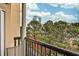 Balcony view features seating and city views framed by lush greenery at 1 Biscayne Nw Dr # 706, Atlanta, GA 30309