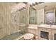 Modern bathroom with glass shower, unique textured tile, and a well-lit vanity at 1 Biscayne Nw Dr # 706, Atlanta, GA 30309