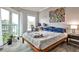 Bedroom featuring a walkout balcony, modern décor, and lots of natural light at 1 Biscayne Nw Dr # 706, Atlanta, GA 30309