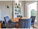 Dining area featuring a round wooden table, four chairs, built-in shelves, and natural light at 1 Biscayne Nw Dr # 706, Atlanta, GA 30309