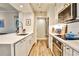 Contemporary kitchen with stainless steel appliances, white cabinetry, and quartz countertops at 1 Biscayne Nw Dr # 706, Atlanta, GA 30309