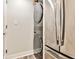 Convenient laundry area featuring stacked washer and dryer next to stainless fridge at 1 Biscayne Nw Dr # 706, Atlanta, GA 30309