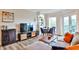 Living room with a sectional sofa, modern entertainment center, dining table, and balcony access at 1 Biscayne Nw Dr # 706, Atlanta, GA 30309