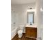 Bathroom featuring a shower-tub combination, wood cabinets and brushed nickel hardware at 3451 Meadow Grass Dr, Dacula, GA 30019
