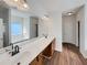 Bathroom featuring double sink vanity with a marble countertop and a large mirror at 3451 Meadow Grass Dr, Dacula, GA 30019