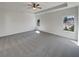 Bright bedroom showcasing a tray ceiling, neutral carpet, and natural light from double hung windows at 3451 Meadow Grass Dr, Dacula, GA 30019