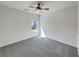 Bright bedroom with neutral carpet, ceiling fan, and natural light from the window at 3451 Meadow Grass Dr, Dacula, GA 30019
