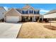 Charming two-story home featuring a brick and siding exterior, manicured lawn, and a welcoming front porch at 3451 Meadow Grass Dr, Dacula, GA 30019