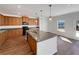 Well-equipped kitchen with stainless steel appliances, granite countertops, a center island, and wooden cabinets at 3451 Meadow Grass Dr, Dacula, GA 30019