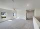 Open concept living room featuring ample lighting, ceiling fan, and neutral carpet at 3451 Meadow Grass Dr, Dacula, GA 30019