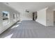 Spacious living room with plush carpeting, abundant natural light from large windows, and neutral paint at 3451 Meadow Grass Dr, Dacula, GA 30019