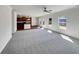 Open-concept living room with carpet flooring flowing into a kitchen with stainless appliances and a center island at 3451 Meadow Grass Dr, Dacula, GA 30019