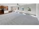 Open-concept living area connecting the kitchen to the living space with lots of natural light from large windows at 3451 Meadow Grass Dr, Dacula, GA 30019